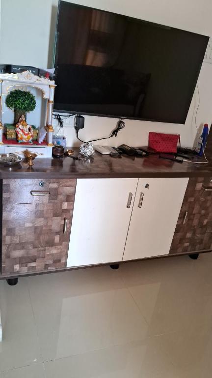 a desk with a television on top of it at Decent furnished 1RK Navi Mumbai in Taloje