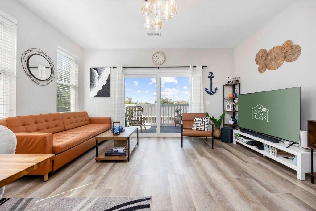 a living room with a couch and a tv at DERBY BLUE A- Ocean Views- Garage & EV Charger in Myrtle Beach