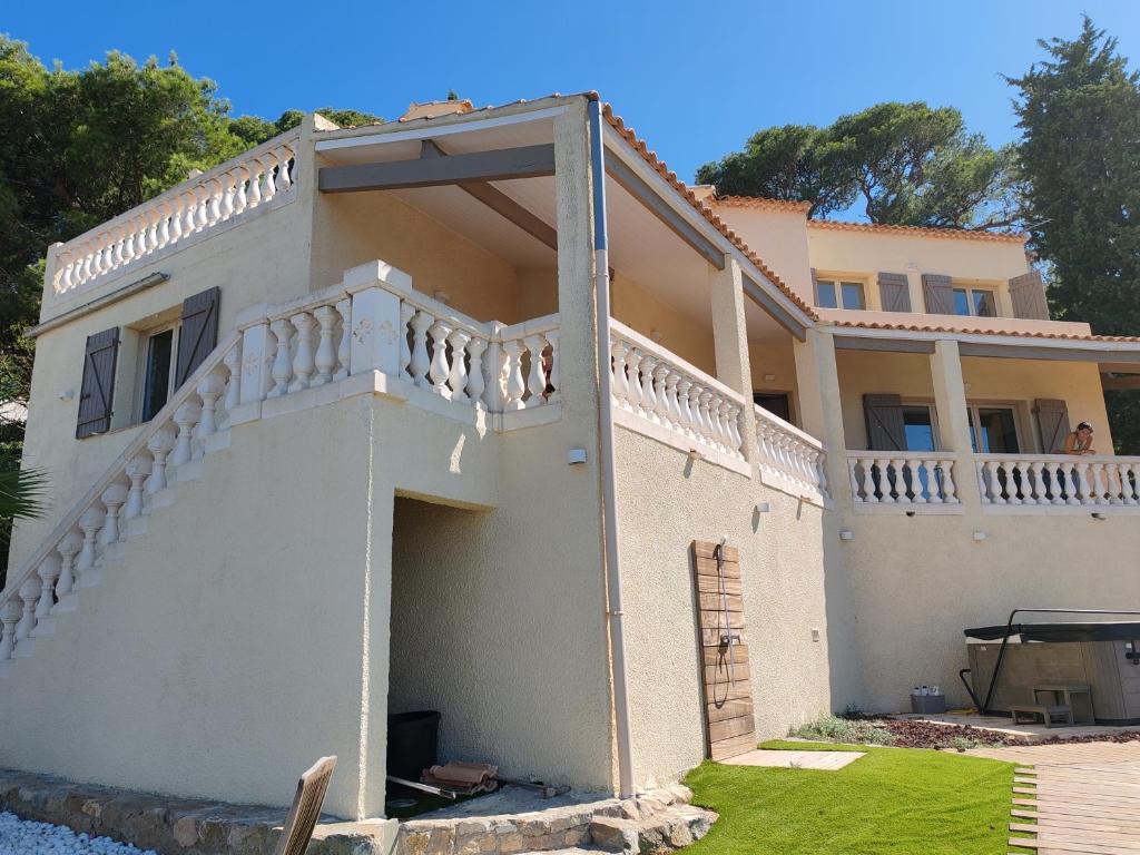 a large white house with a balcony at L'Occitane bleu in Sète