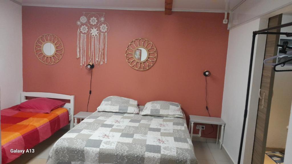 Postel nebo postele na pokoji v ubytování FRUITS DE LA PASSION