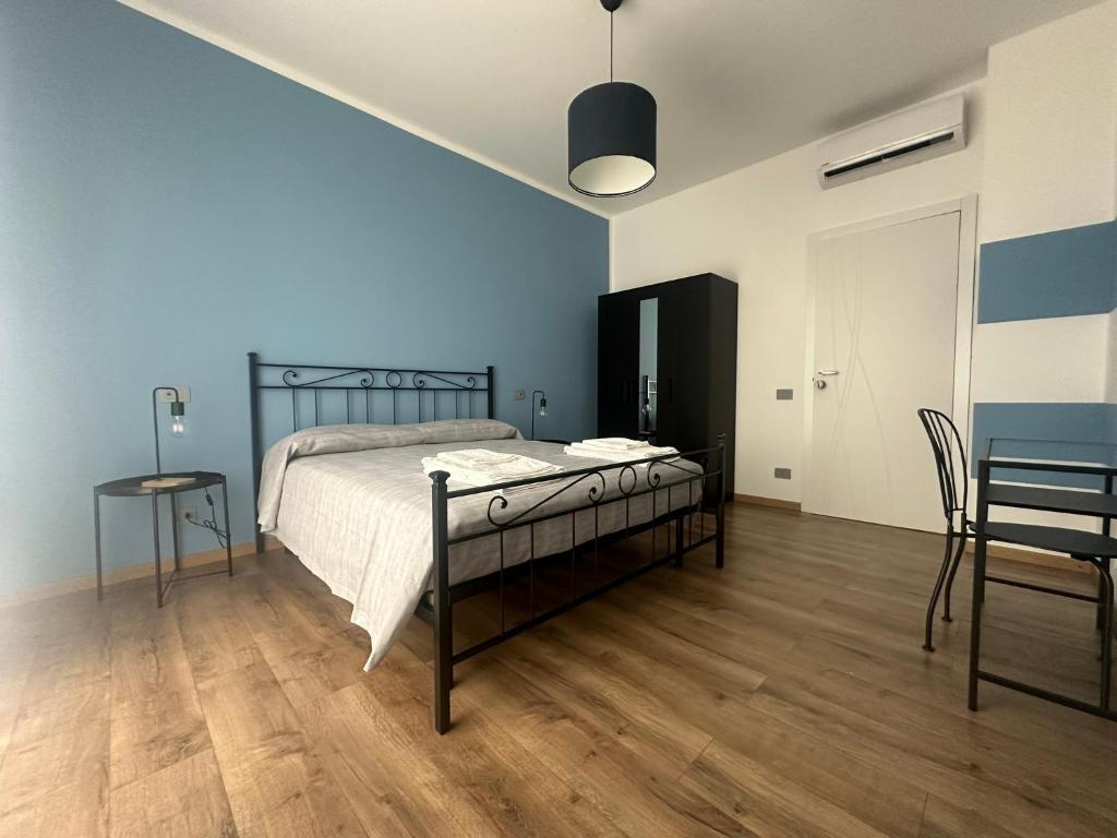 a bedroom with a bed and a table and chairs at Appartamento La Ginestra in Gozzano