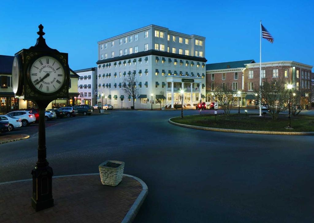 a clock in the middle of a street with a building at Gettysburg Hotel in Gettysburg