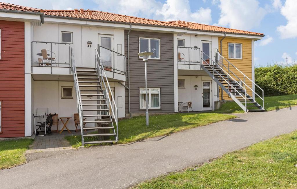 a house with a staircase on the side of it at Gudhjem Søpark Lejl 42 in Gudhjem