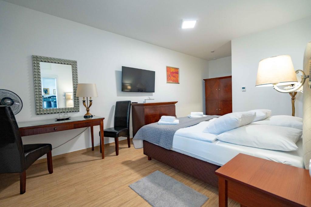 Postel nebo postele na pokoji v ubytování Hotel Volf