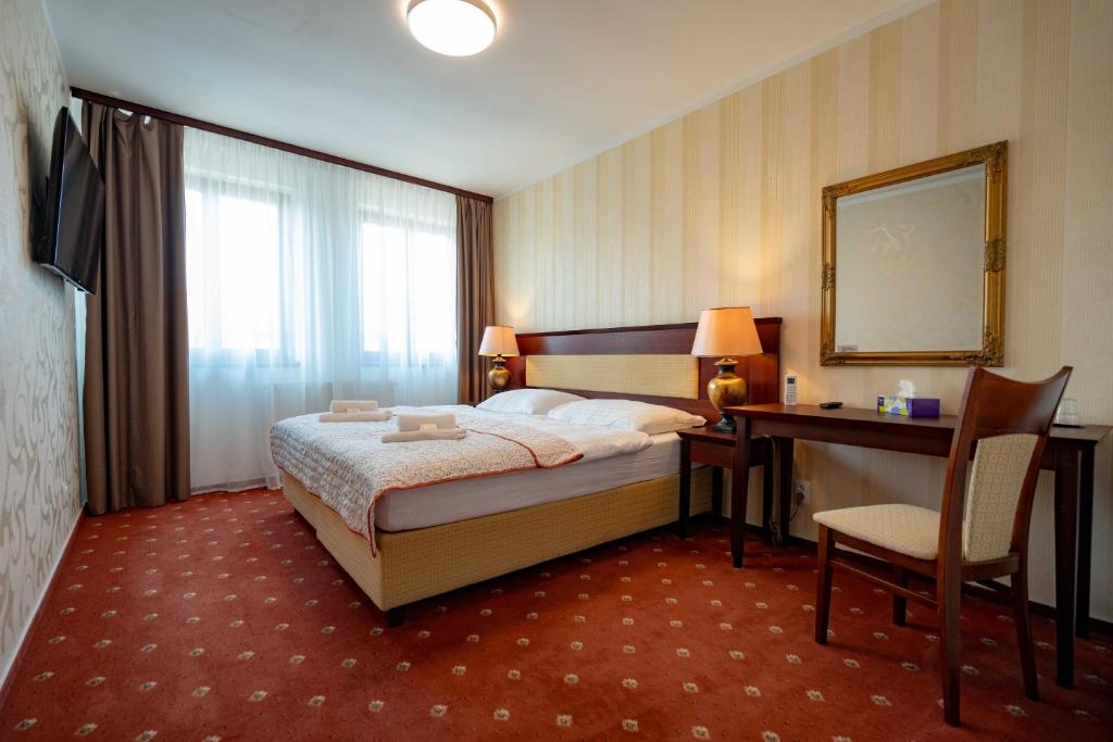 Postel nebo postele na pokoji v ubytování Hotel Volf