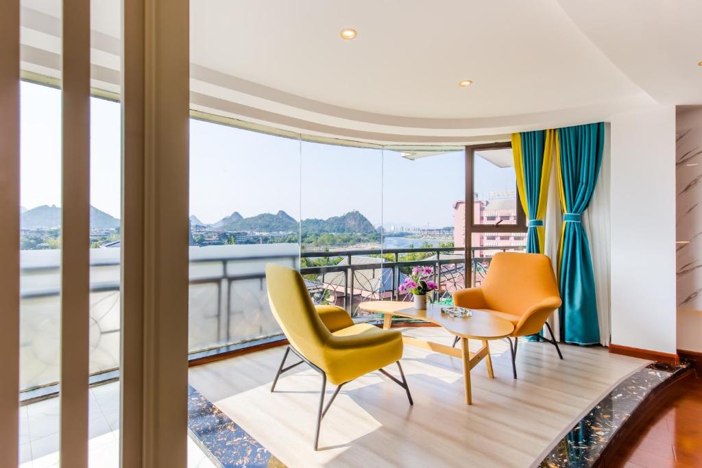 a living room with yellow chairs and a table at 桂林依庐居民宿 in Guilin