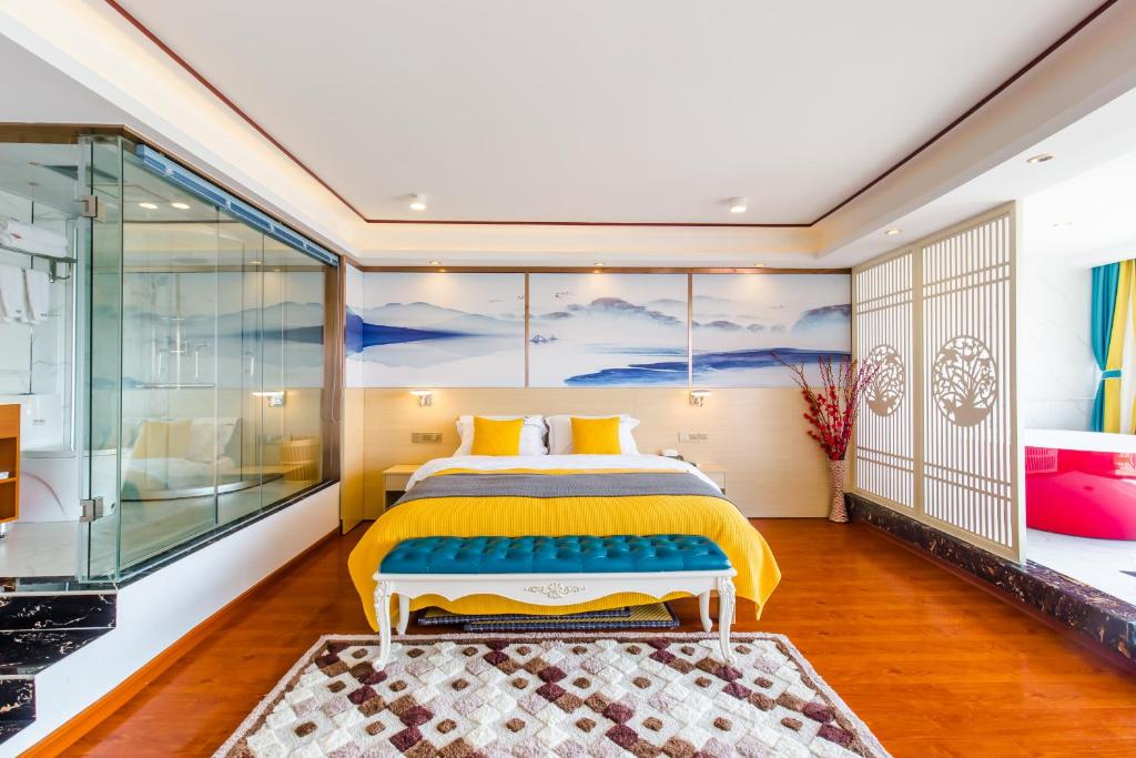 a bedroom with a bed and a glass wall at 桂林依庐居民宿 in Guilin