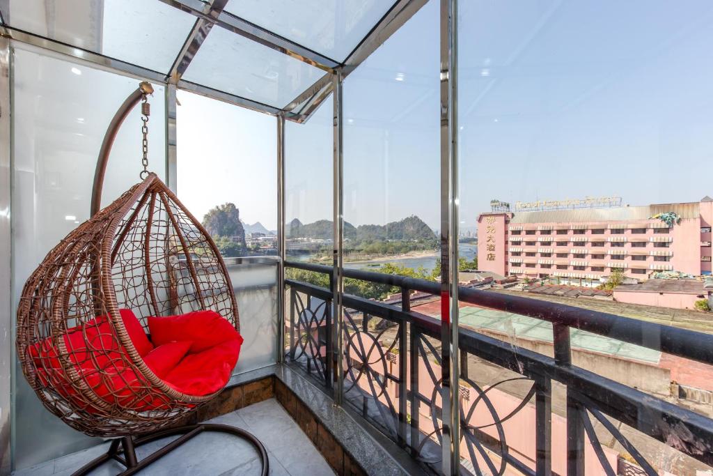 a hanging hammock on a balcony with a view at 桂林依庐居民宿 in Guilin