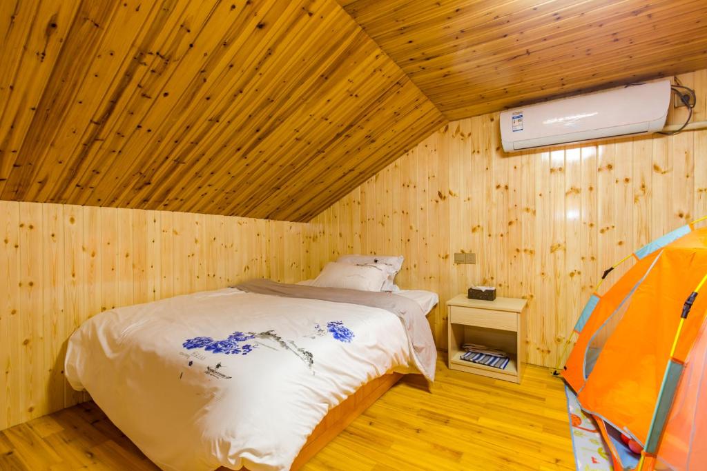 a bedroom with a bed in a wooden room at 桂林依庐居民宿 in Guilin