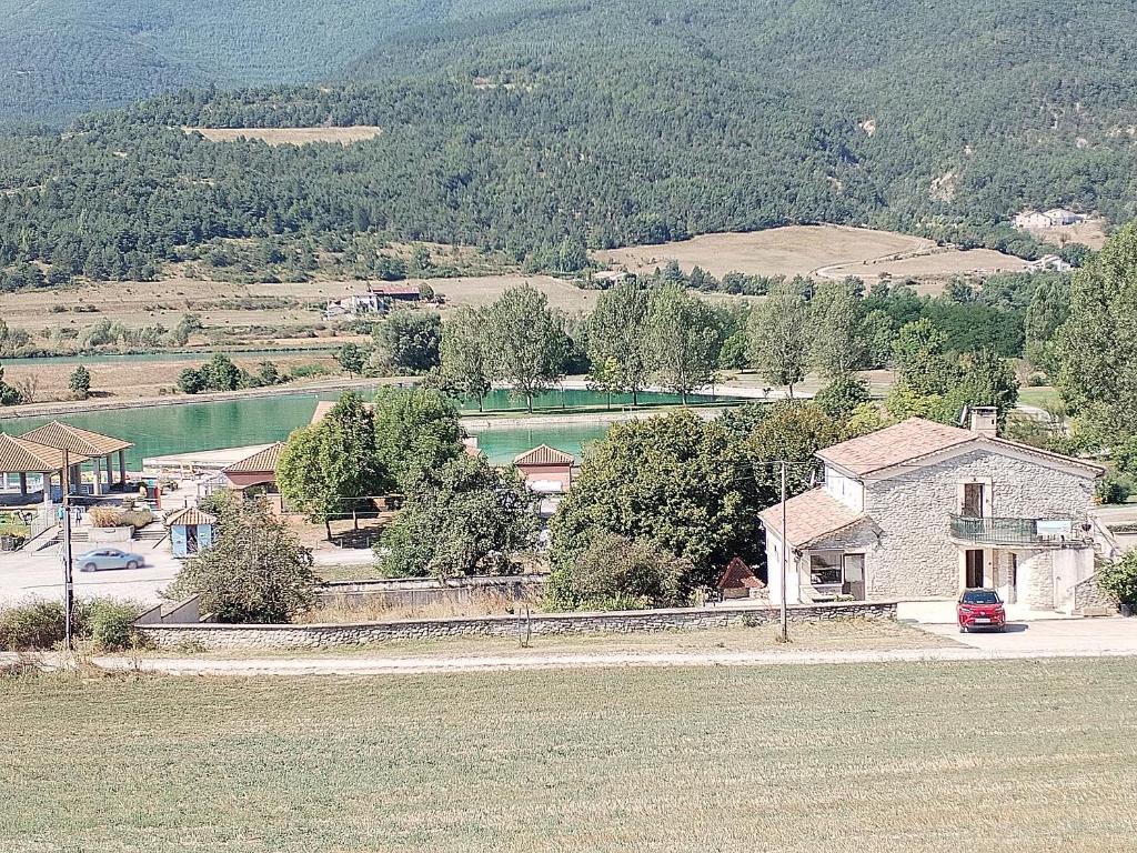 an aerial view of a small town with a lake at La petite Ginette in Serres