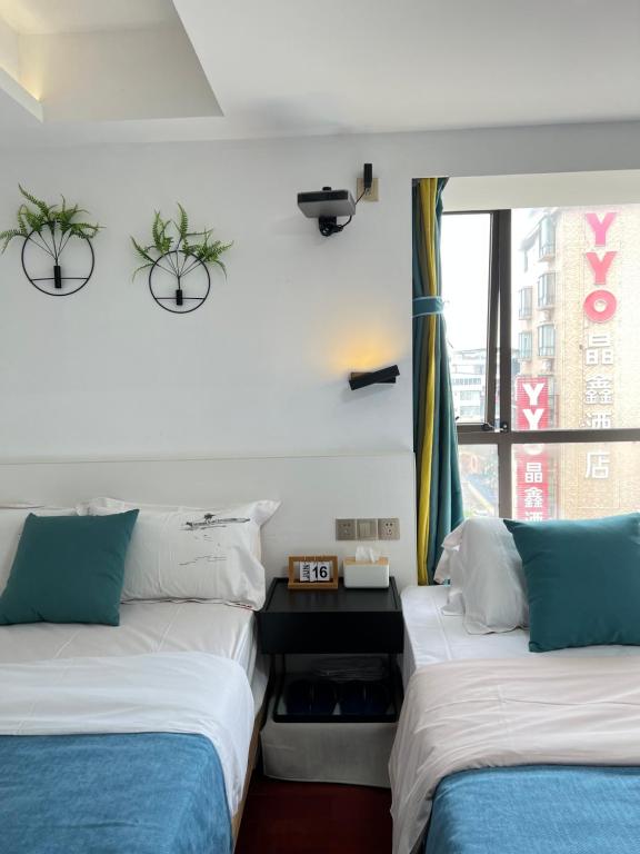 two beds sitting next to each other in a room at 桂林依庐居民宿 in Guilin