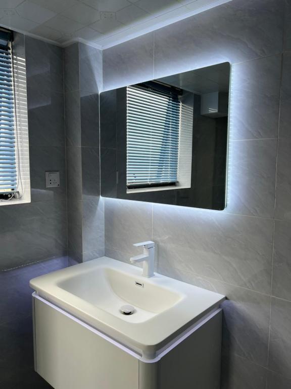 a bathroom with a white sink and a mirror at 桂林依庐居民宿 in Guilin