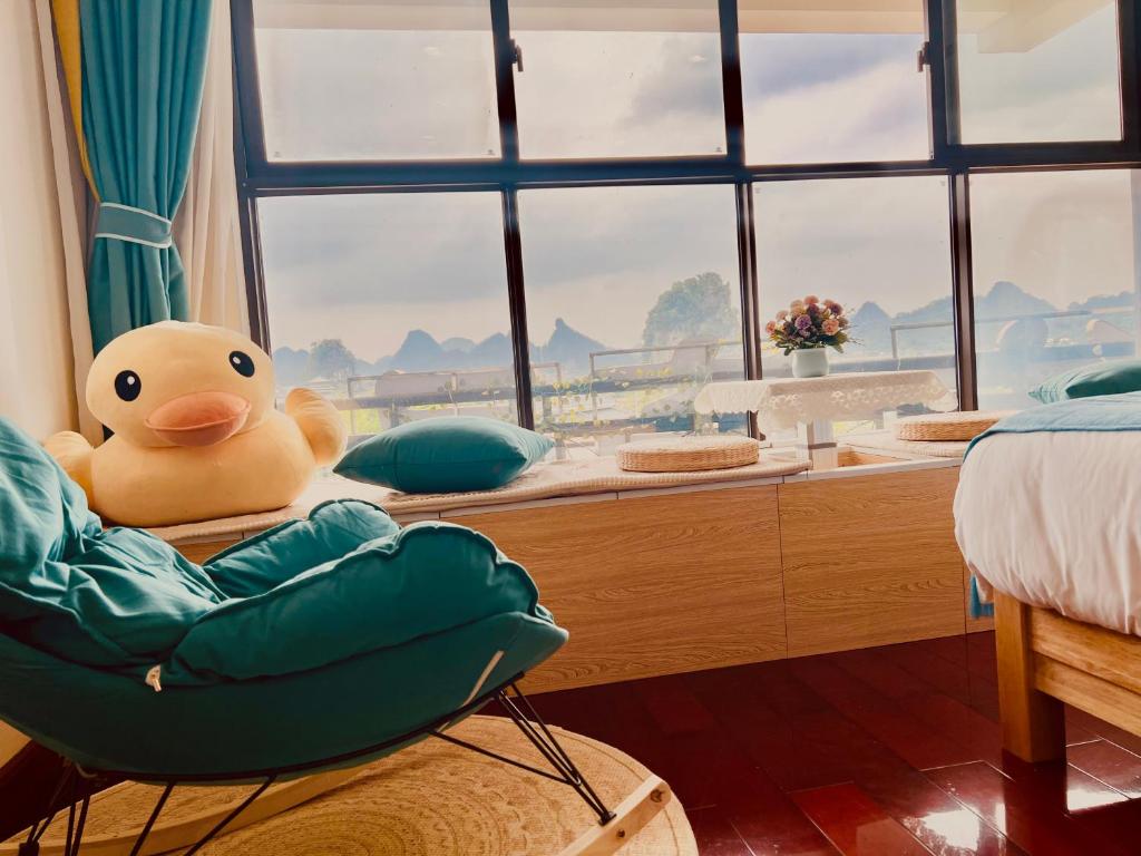 a stuffed duck sitting on a table in a bedroom at 桂林依庐居民宿 in Guilin