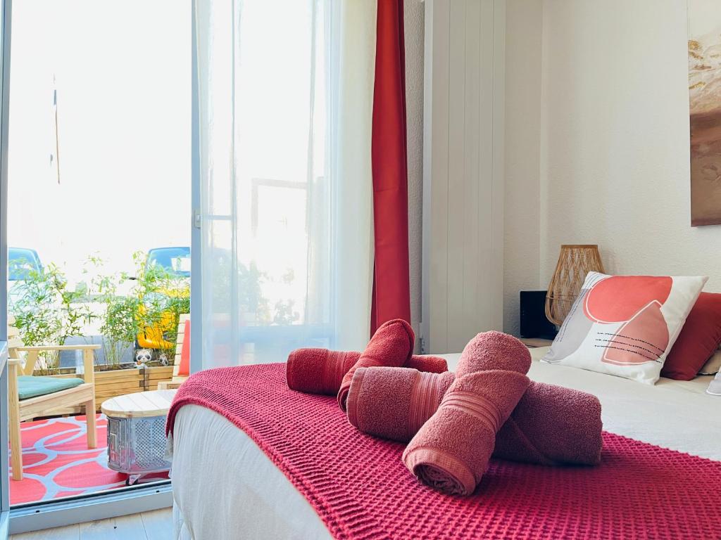 un ours en peluche farci assis au-dessus d'un lit dans l'établissement Le Mirage - Studio - Parking - Terrasse - 2 pers, au Mans