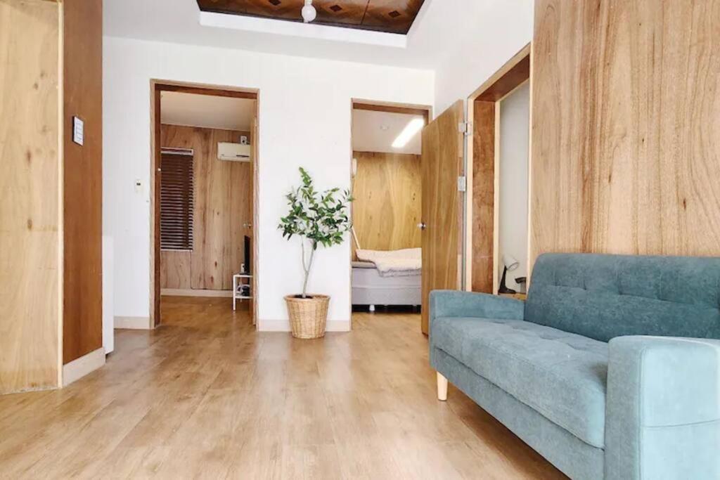 a living room with a blue couch and a bedroom at 한옥스타일 Hongdae 7min #Sinchon 6min in Seoul
