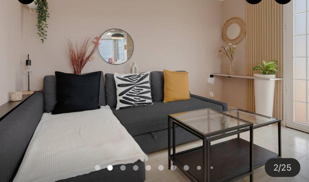 a living room with a couch and a glass table at Las Arenas Family in Costa Calma