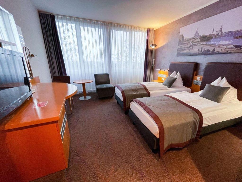 Postel nebo postele na pokoji v ubytování Ramada by Wyndham Dresden
