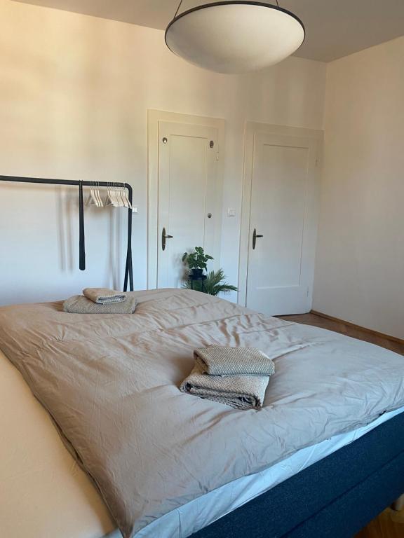 a large bed with two pillows on it in a bedroom at Apartmán v centru Krumlova in Český Krumlov