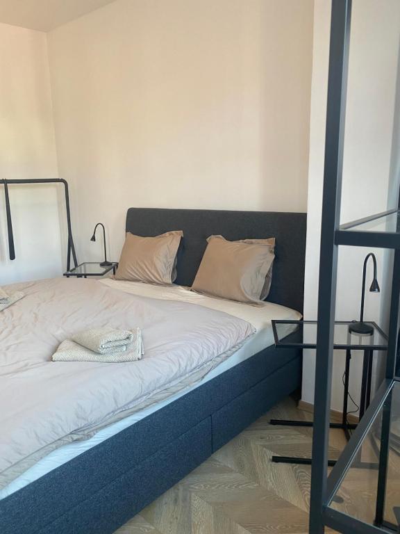 a bed with white sheets and pillows in a room at Apartmán v centru Krumlova in Český Krumlov