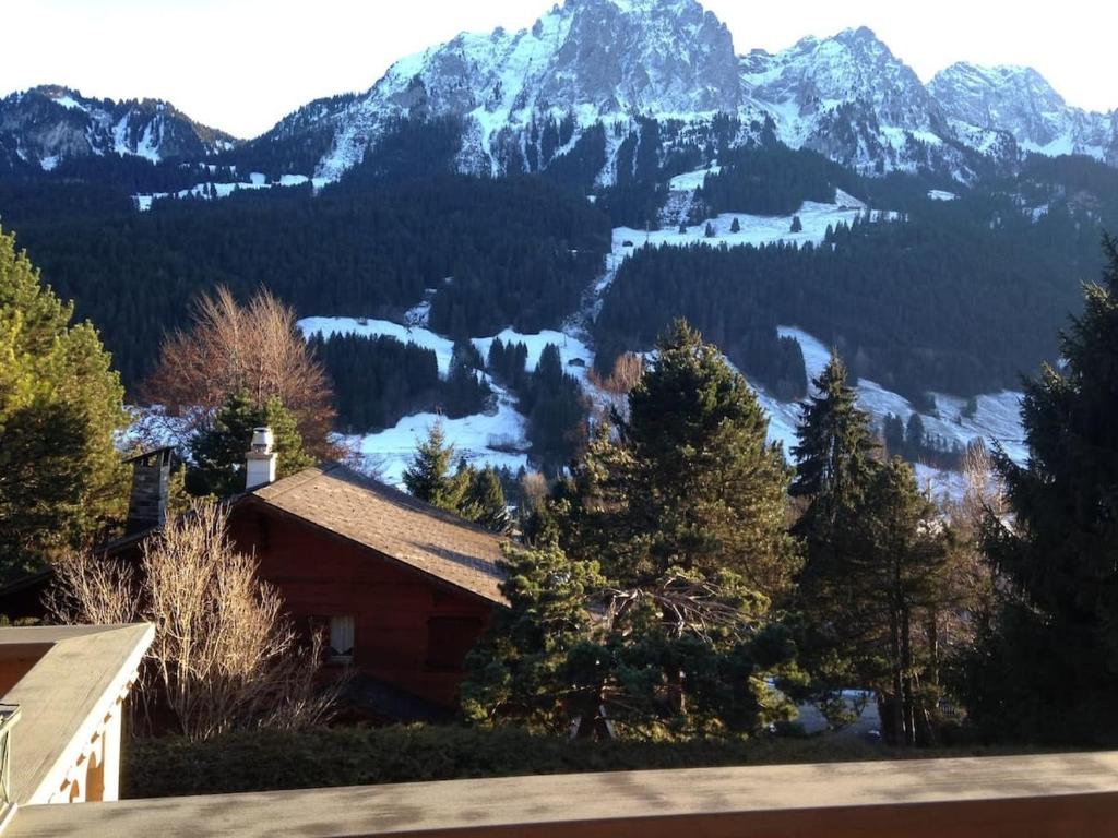 a house with a view of a mountain at Alp Sunrise - Top View Cozy Chalet in Rougemont