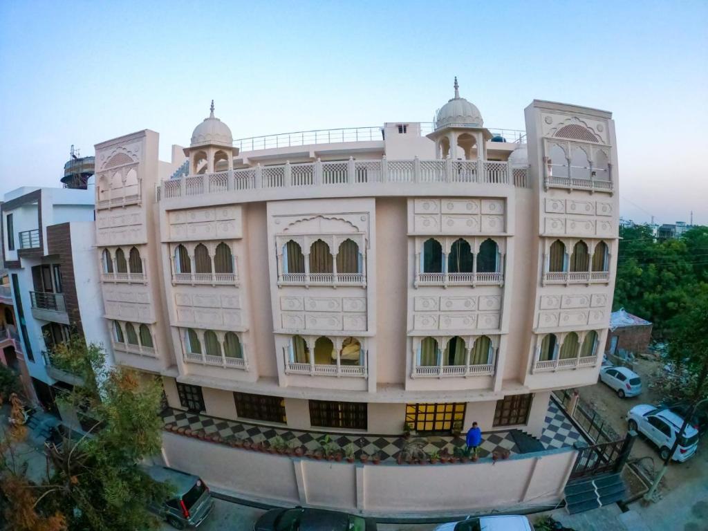 a large white building with a balcony at The Taj Vista Agra -walking distance to Taj Mahal in Agra