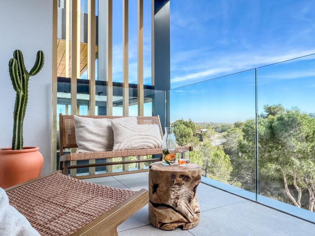 a room with a bench and a cactus on a balcony at Mandarino 15 Las Colinas Golf in Orihuela Costa