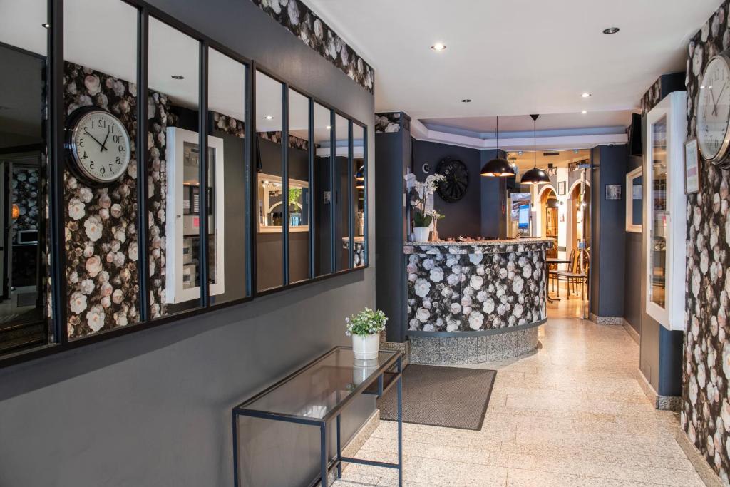 a store with a clock on the wall and a counter at Grand Hôtel De Paris in Paris