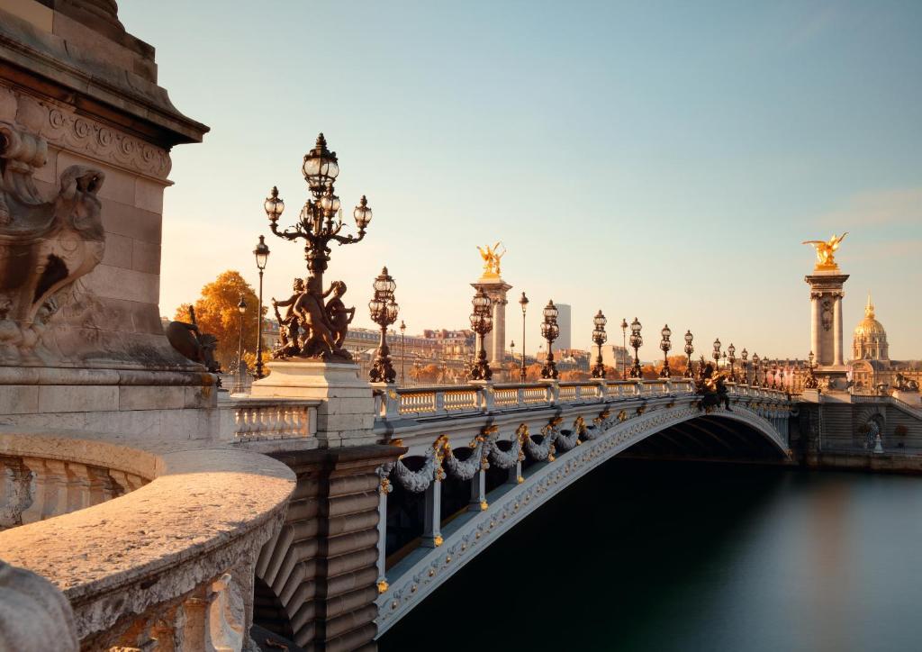 a bridge over a river in a city at Grand Hôtel De Paris in Paris