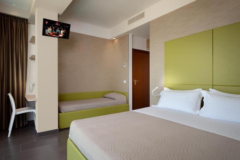 Postel nebo postele na pokoji v ubytování Hotel Excelsior