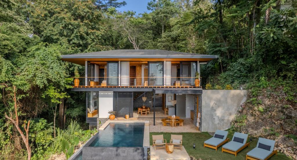 a house in the woods with a swimming pool at Brand-new luxury Villa Element in Carmen