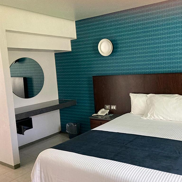 Postel nebo postele na pokoji v ubytování Hotel Y Parque Acuático La Caldera