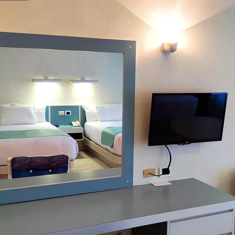 Postel nebo postele na pokoji v ubytování Hotel Y Parque Acuático La Caldera