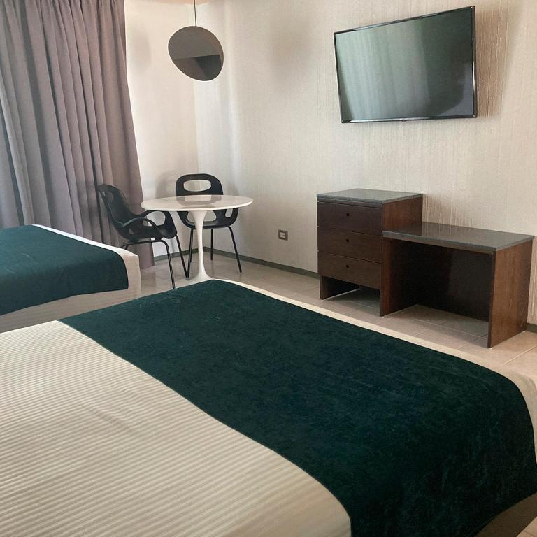 Postel nebo postele na pokoji v ubytování Hotel Y Parque Acuático La Caldera