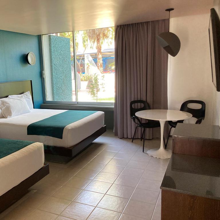 Postel nebo postele na pokoji v ubytování Hotel Y Parque Acuático La Caldera