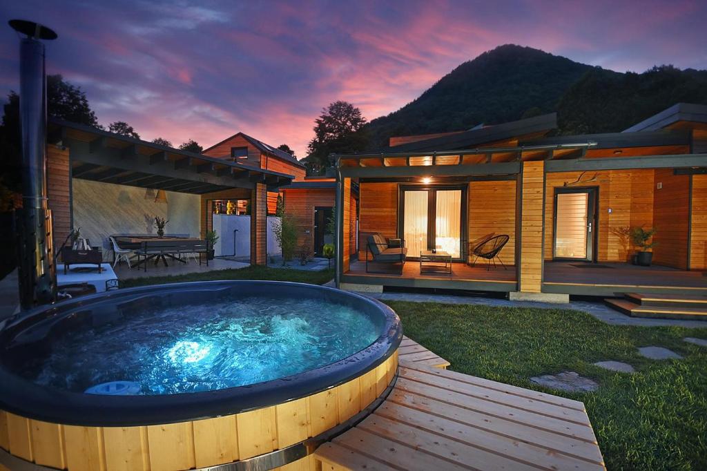 a large hot tub in a yard next to a house at Casa Twins - Slanic Moldova in Slănic-Moldova