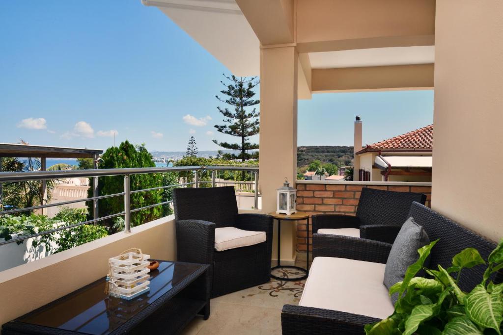a balcony with chairs and a table and a view at Favola Golden Beach Villa in Daratso