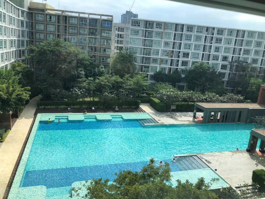 a large swimming pool in the middle of a building at D condo sign D4 in Chiang Mai