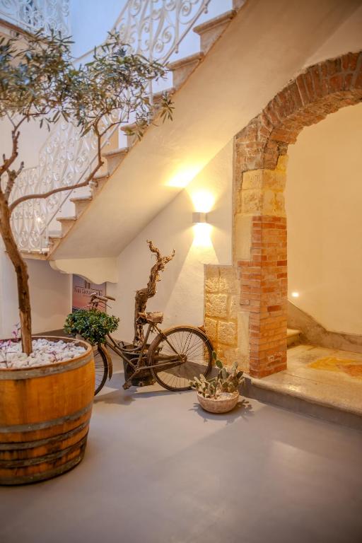 a bike in a room with a tree in a barrel at Residenza San Giovannello in Marsala