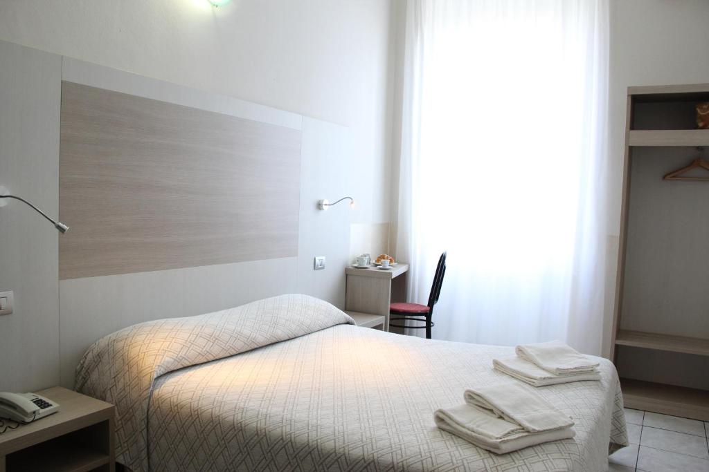 Postel nebo postele na pokoji v ubytování Hotel Due Giardini