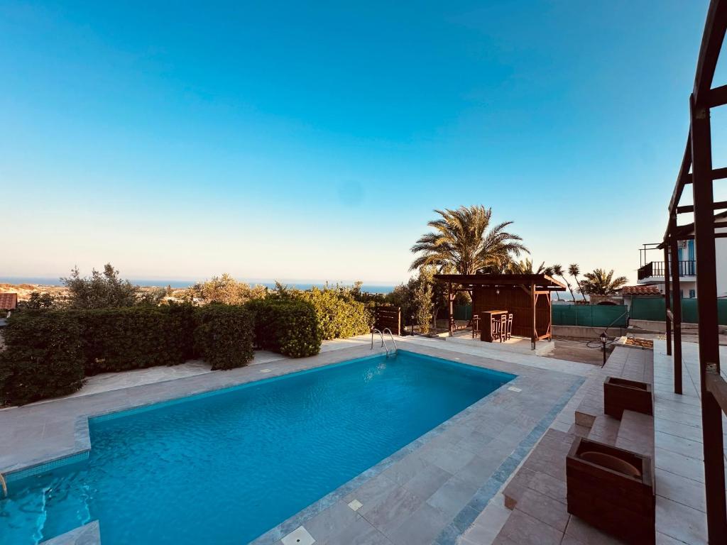 a swimming pool in the middle of a yard at House in Maroni in Pervolia