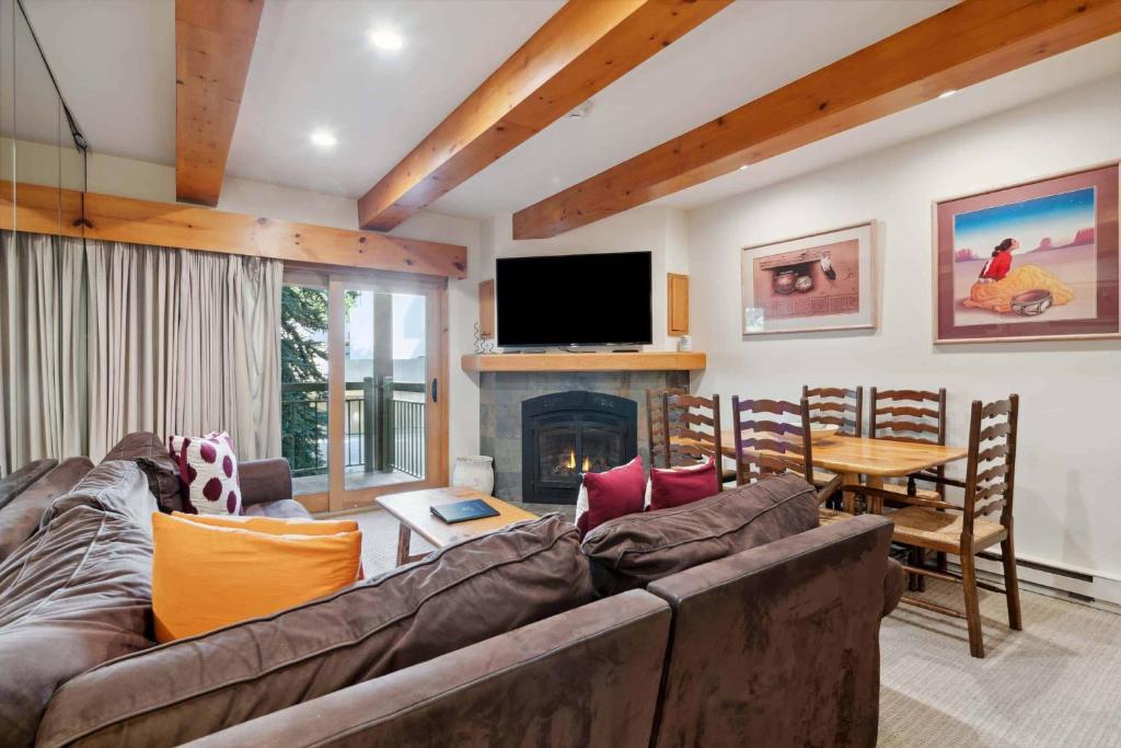 a living room with a couch and a fireplace at Lodge at Lionshead 110-100 in Vail