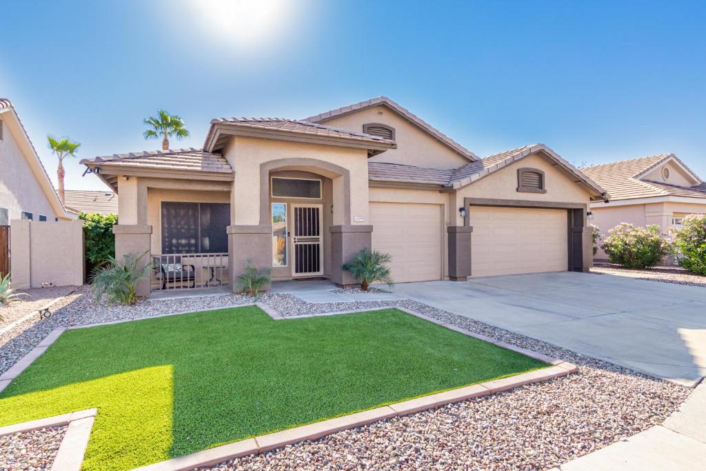 a house with a green lawn in front of it at Harrison Chandler in Chandler