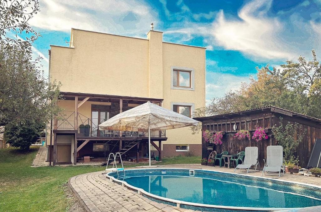 a house with a swimming pool in front of a house at Villa Stella in Prešov