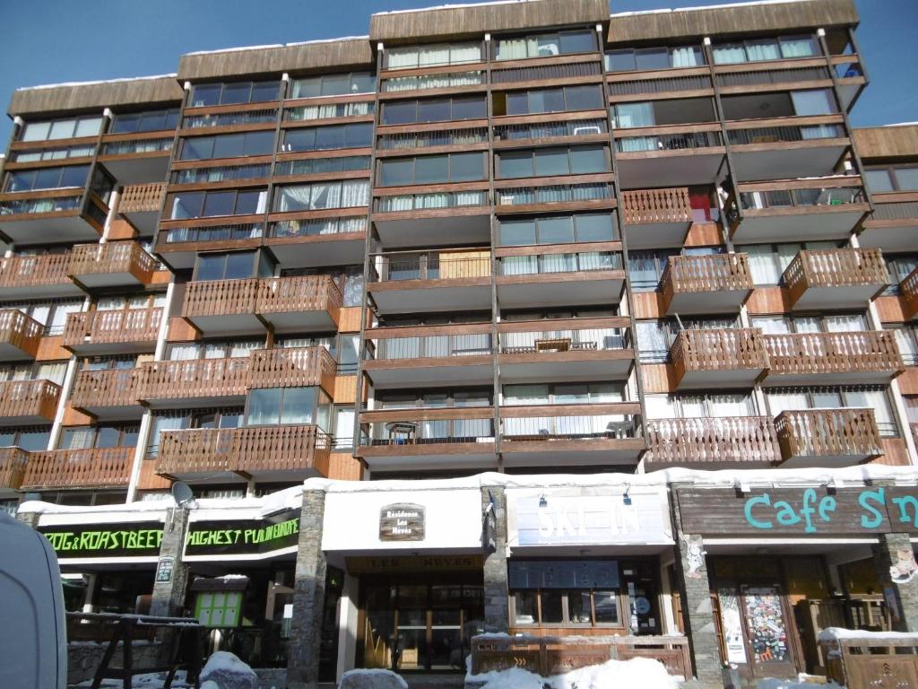 a tall building with balconies on the side of it at Neves in Val Thorens