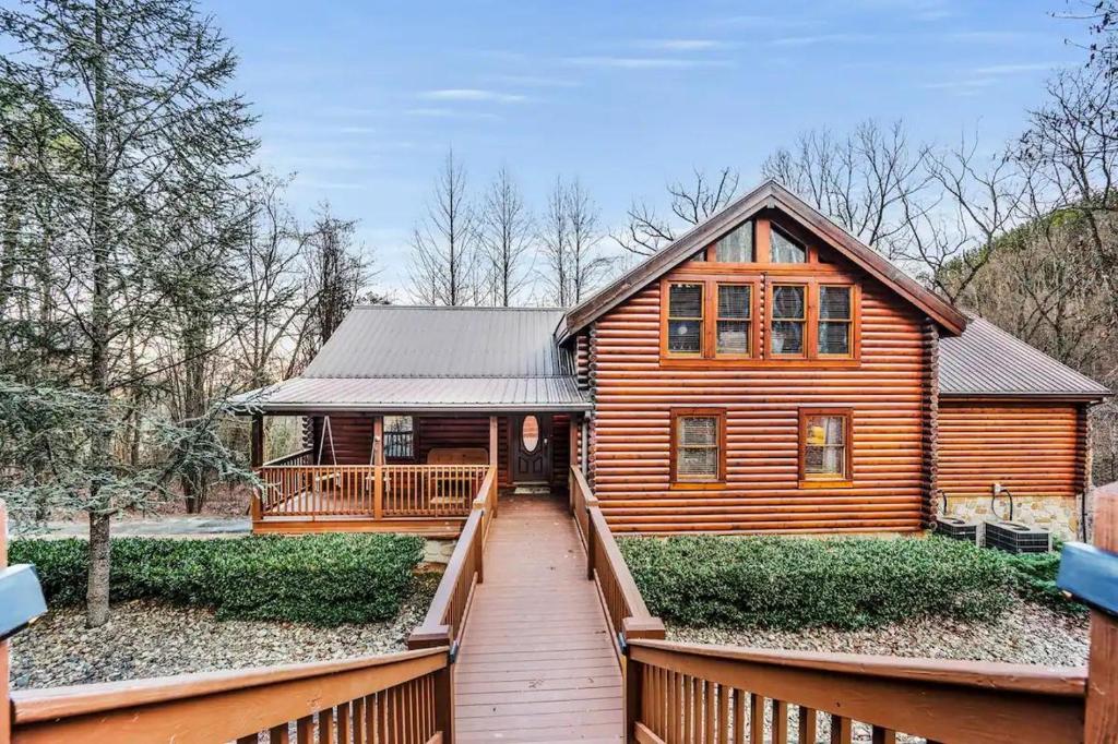 a wooden house with a wooden walkway in front of it at Round Top Way Cabin By Beyond Expectations in Sevierville