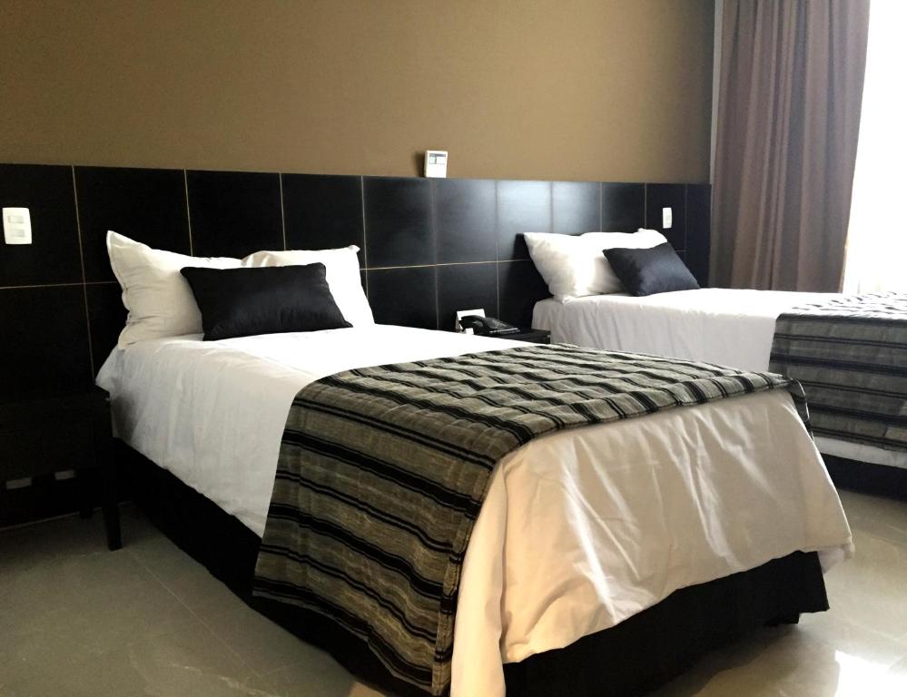 Postel nebo postele na pokoji v ubytování Hotel Atlântico Tower