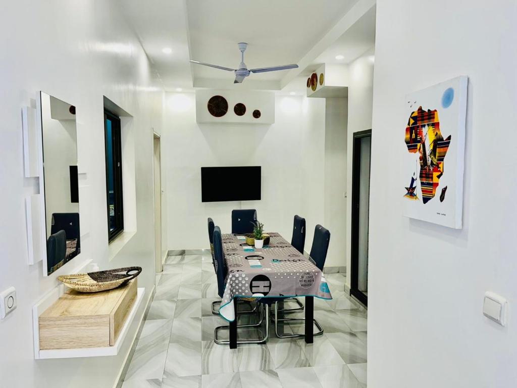 a dining room with a table and chairs at Belle VILLA Apt Mamelles, Monument de la renaissance arrondissement ALMADIES in Ouakam