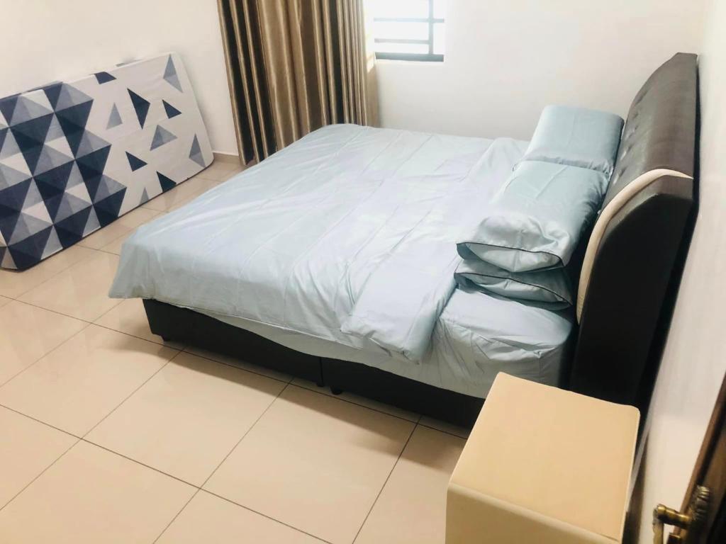 Postel nebo postele na pokoji v ubytování Happy Guest House Nibong Tebal 开心民宿高渊区