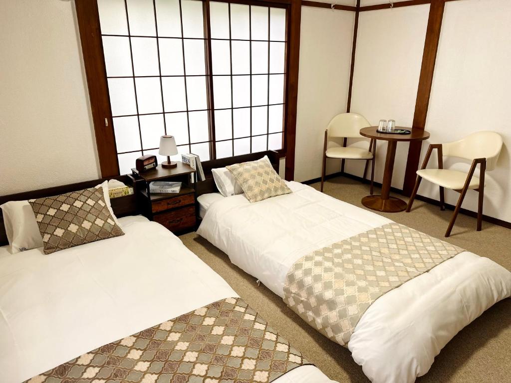 Postel nebo postele na pokoji v ubytování 湯沢雪の宿 YUZAWA Snow Inn-Ski IN Ski OUT