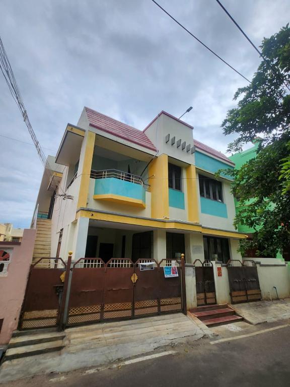 a house with a fence in front of it at Holiday Home Madurai Bharathi Nagar - FF in Tallākulam
